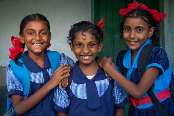 Smiling Three indian Rural School Girl wearing School Uniform Standing in school