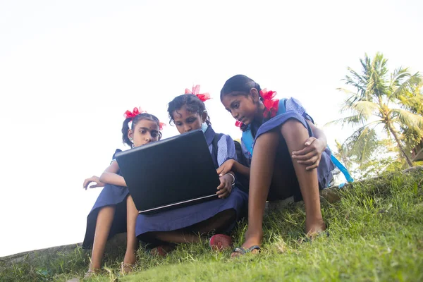 indian village government school girls operating laptop computer system at rural area in india