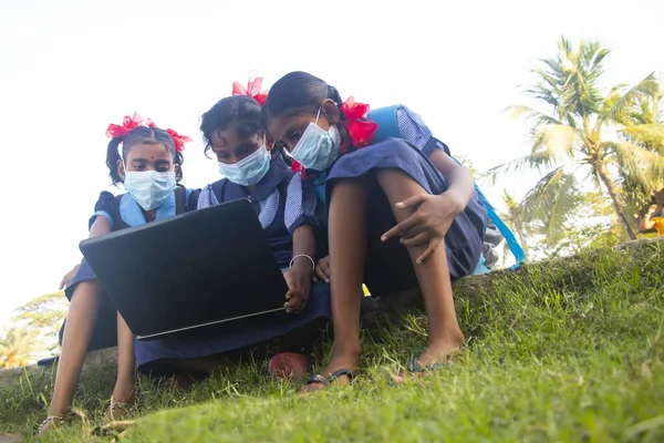 indian village government school girls operating laptop computer system at rural area in india