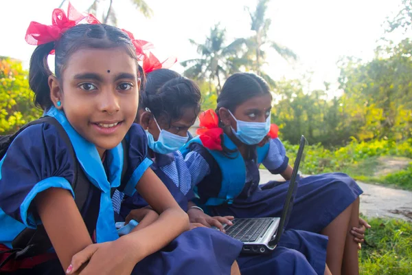 indian village government school girls operating laptop computer system at rural area in india