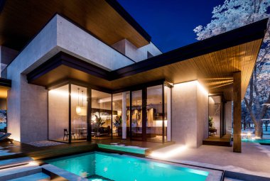 Otoparkı ve havuzu satılık ya da kiralık iki katlı evin beton cepheli ve arka planda güzel bir peyzajı var. Gökyüzündeki yıldızlarla serin bir kış gecesi