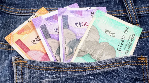 Closeup view of jeans with Indian money