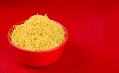 Hint baharatlı çerezi besan sev, diwali yemeği kırmızı arka planda.