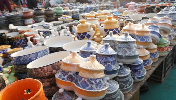 Collection of colorful pots and vases in market for selling