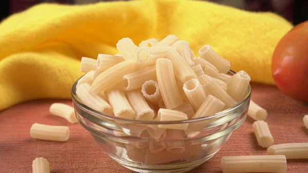 Raw Penne Pasta Bowl Orange Background — Stock Photo, Image