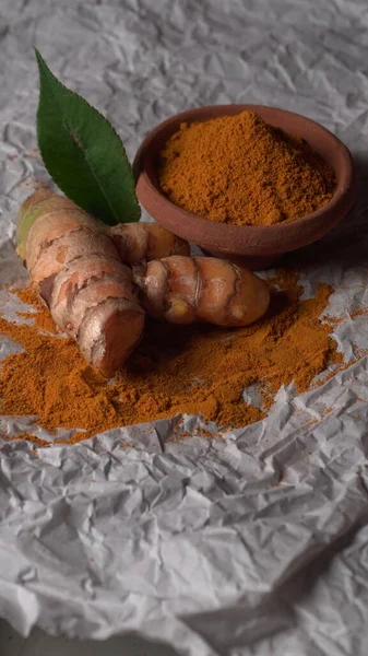 Fresh turmeric roots on textured background. Herbs are native, Food and drink, diet nutrition, health care concept.