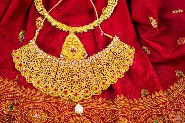 Indian Traditional gold Jewelry on cloth background.