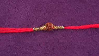 Hint festivali: Raksha Bandhan özgeçmişi zarif bir Rakhi, pirinç taneleri ve Kumkum ile. Geleneksel Hint bilekliği Kardeşler ve Kız Kardeşler arasındaki aşkın sembolüdür..