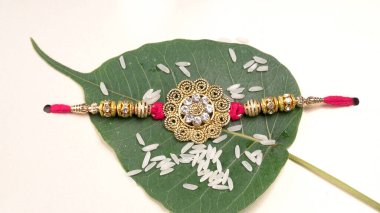 Geleneksel Hint Bilekliği Rakhi 'ye pirinç taneli diyor, Kardeş Bileklerine Raksha bandosu takıyor