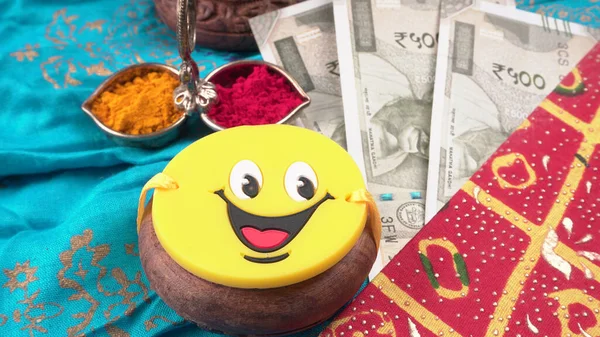 Pile of Indian Money With Traditional Indian Bracelet Calls Rakhi, Sister Ties On Brothers Wrist on the Ocassion of Raksha bandhan