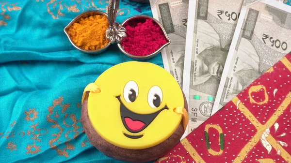 Pile of Indian Money With Traditional Indian Bracelet Calls Rakhi, Sister Ties On Brothers Wrist on the Ocassion of Raksha bandhan