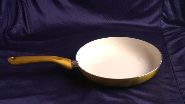 Golden Frying Pan Ceramic Blue Cloth Background — Stock Photo, Image