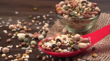 Ahşap arka planda çeşitli fasulye yığınları. Sağlıklı gıda konsepti