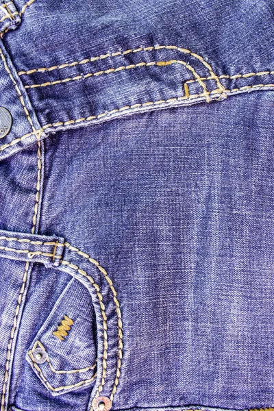 Fragment of the old worn blue denim with a horizontal seam — Stock Photo, Image