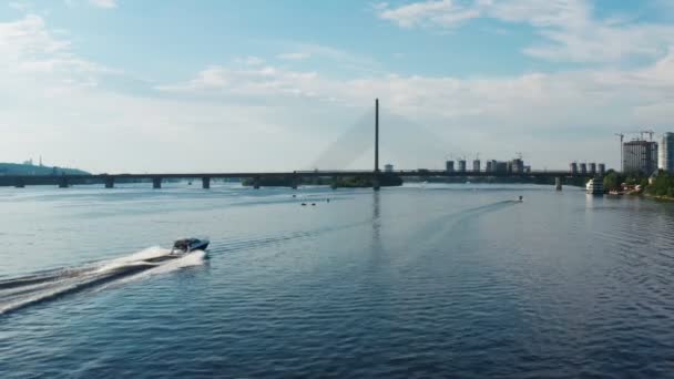 Vista aérea de la lancha a motor navegando en el río en el fondo del paisaje urbano — Vídeos de Stock