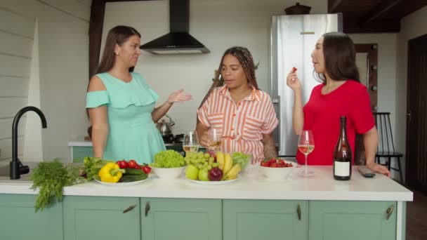 Three interethnic female friends taking selfies on phone in kitchen — Stock Video