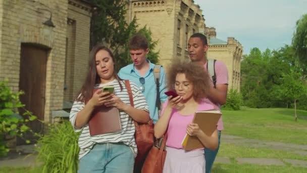 Mixed race students using mobile app, photographing outdors at sunset — Vídeo de Stock