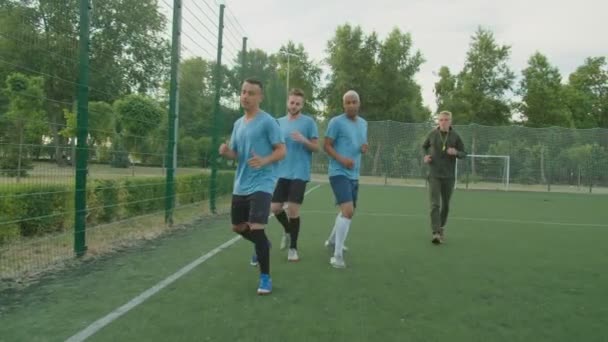 Fotballspillere som utfører sideveis trimming utendørs ved daggry – stockvideo