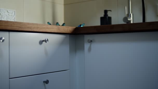Unrecognizable womans hand opening cupboard drawer in kitchen indoors — Stock Video