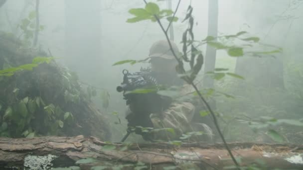 Gunner and sniper with weapon sitting in wait in concealed position — Stock Video