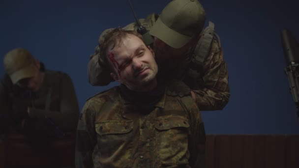 Портрет военнопленного в камуфляже во время допроса в помещении — стоковое видео