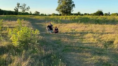 Bir anne ve oğlu doğada birlikte köpeklerini gezdirirken bir aile anı başlar. Sıcak akşam ışığı, ülke yaşamını, aile zamanlarını ve ebeveynler ile çocuklar arasındaki şefkatli bağı yansıtır..