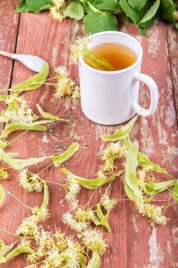 Linden çay bir fincan ahşap arka plan üzerinde.