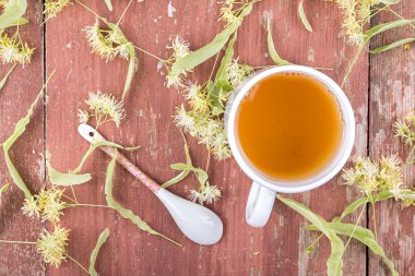 Linden çay bir fincan ahşap arka plan üzerinde.