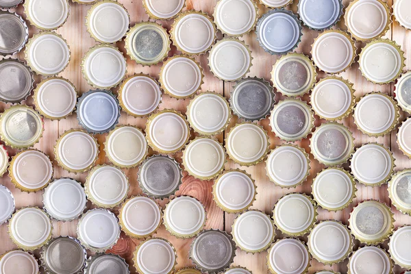 caps of beer lined up in rows top view