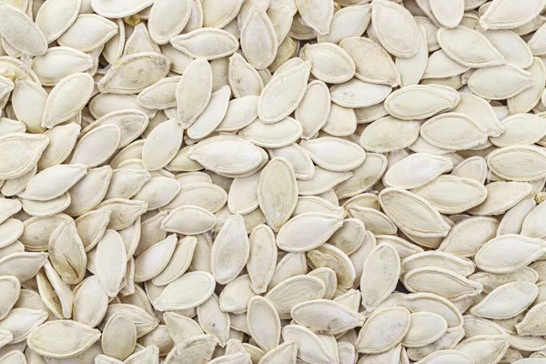 Pumpkin seeds background. Top view.