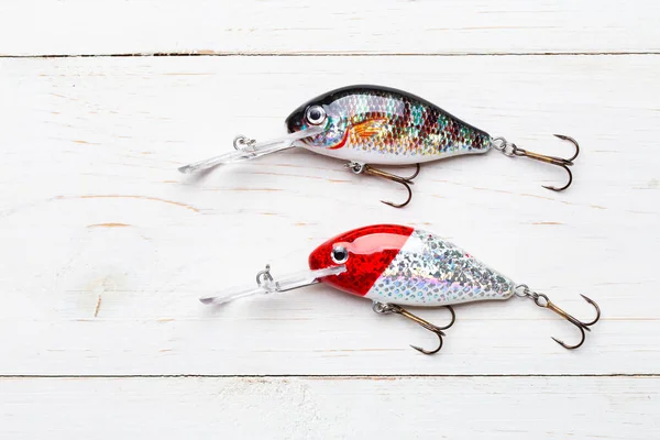 Wobbler perch or pike bait. Fishing bait tackle and baubles for fishing on a wood background.