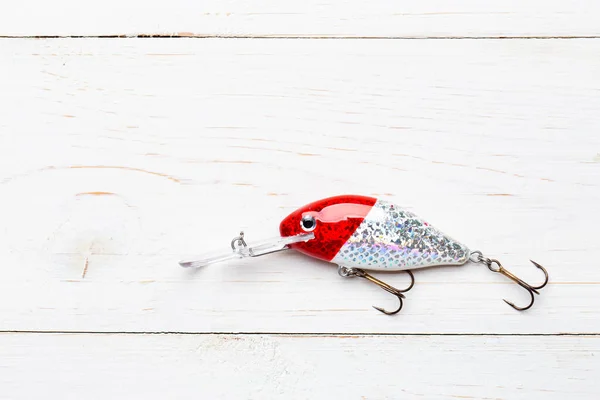 Wobbler perch or pike bait. Fishing bait tackle and baubles for fishing on a wood background.