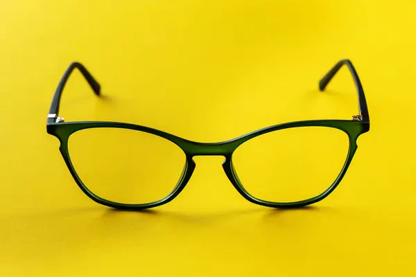 Stylish glasses on a yellow background. Health, style and business concept. Eyesight correction.