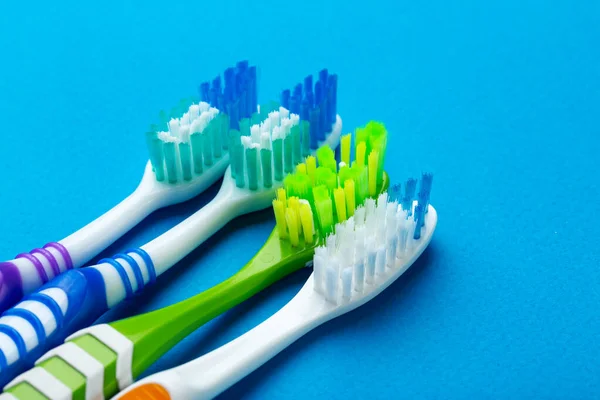 Toothbrushes on a blue background. Concept toothbrush selection. Oral cavity care. Dental hygiene. Top view.