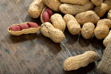 Ahşap bir masada soyulmamış fıstık..