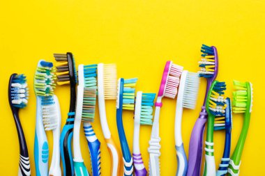 Toothbrushes on a yellow background. Concept toothbrush selection. Oral cavity care. Dental hygiene.