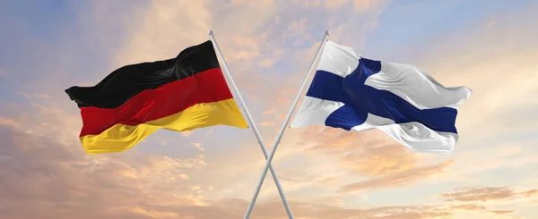 Flaggor Tyskland Och Finland Vinkar Vinden Flaggstänger Mot Himlen Med — Stockfoto