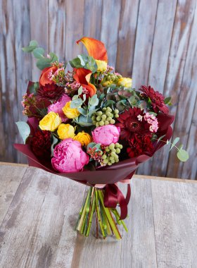 Düğün buketi agaist ahşap duvar. Taze, yemyeşil renkli çiçekler.