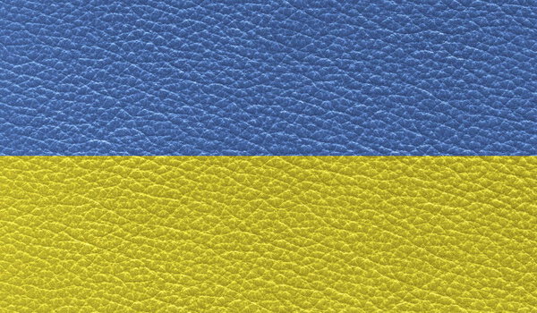 flat flag of Ukraine printed on leather texture background. Top view