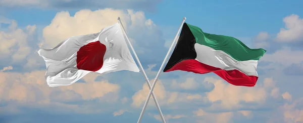 阳光明媚的日子 日本和科威特的国旗在风中飘扬 旗杆迎着天空飘扬 象征两国关系 两国间的对话 3D说明 — 图库照片