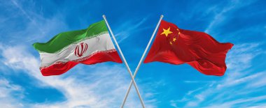 Çin ve İran 'ın bayrakları rüzgarda dalgalanırken bayrak direkleri gökyüzüne karşı güneşli bir günde bulutlarla. İki ülke arasındaki ilişkiyi, diyaloğu sembolize ediyor. 3d illüstrasyon,