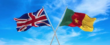 flags of great Britain and Cameroon waving in the wind on flagpoles against sky with clouds on sunny day. Symbolizing relationship, dialog between two countries. 3d illustration,