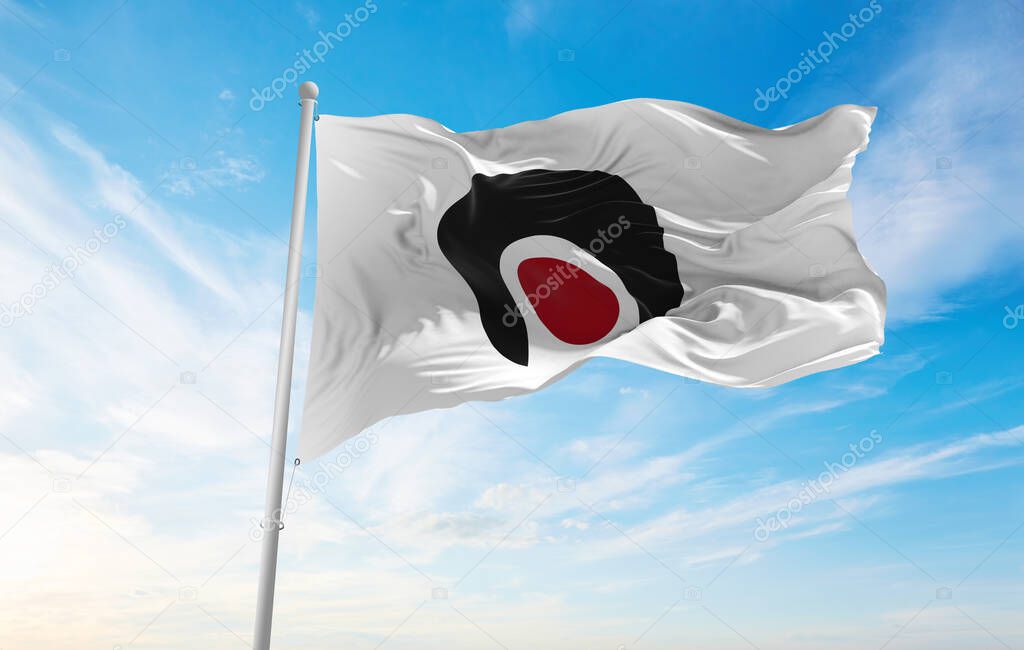 official flag of Kagoshima prefecture waving in the wind on flagpoles against sky with clouds on sunny day. Japan Patriotic concept. 3d illustration.