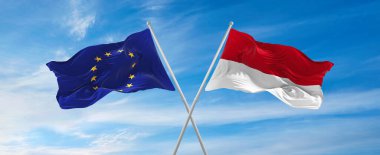 Avrupa Birliği ve Monako 'nun bayrakları güneşli bir günde gökyüzüne karşı bayrak direkleri sallıyor. İki ülke arasındaki ilişkiyi, diyaloğu sembolize ediyor. 3d illüstrasyon,