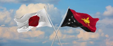 Japonya ve Papua Yeni Gine 'nin bayrakları güneşli bir günde gökyüzünde bayrak direkleri sallıyor. İki ülke arasındaki ilişkiyi, diyaloğu sembolize ediyor. 3d illüstrasyon,