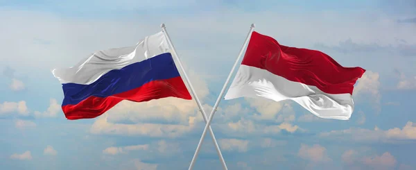 ロシアとインドネシアの旗は 晴れた日に雲と空に対して旗竿に風に振っています 関係を象徴し 両国間の対話 3Dイラスト — ストック写真