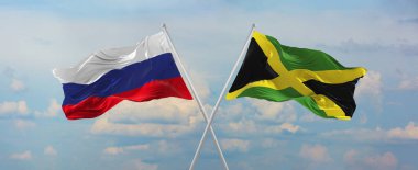 Rusya ve Jamaika 'nın bayrakları rüzgarda dalgalanırken bayrak direkleri gökyüzüne karşı güneşli bir günde bulutlarla. İki ülke arasındaki ilişkiyi, diyaloğu sembolize ediyor. 3d illüstrasyon,