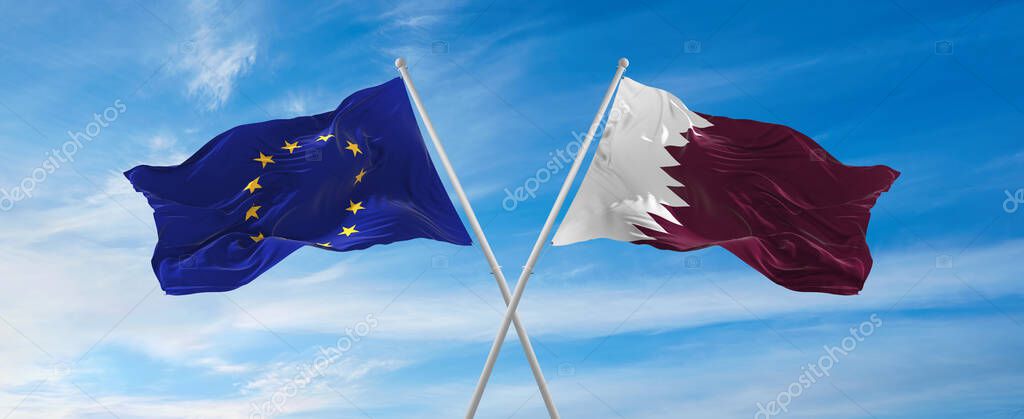Flags of European Union and Qatar waving in the wind on flagpoles against sky with clouds on sunny day. Symbolizing relationship, dialog between two countries. 3d illustration,