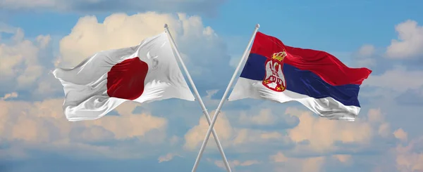 Flags Japan Serbia Waving Wind Flagpoles Sky Clouds Sunny Day — Stock Photo, Image