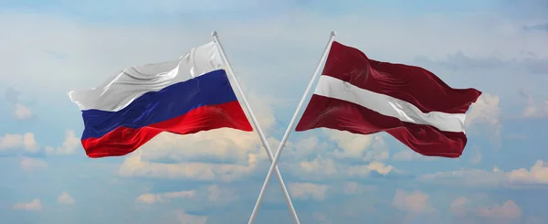 Flaggor Ryssland Och Latvia Vinka Vinden Flaggstänger Mot Himlen Med — Stockfoto